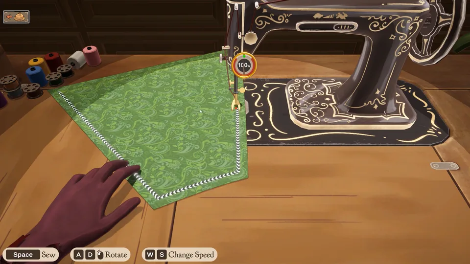 Green patterned fabric being stitched at a vintage sewing machine in the official desktop edition